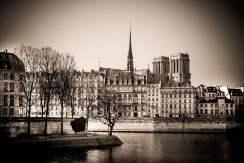 The exterior of Notre Dame Cathedral is prominently displayed along the Seine River in Paris,