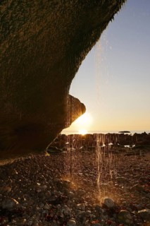 Waterfall on the cliffs backlit at sunset, Etretat, Alabaster Coast, Seine-Maritime, Upper