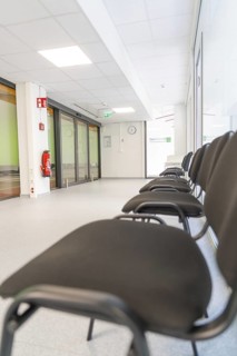 Bright hallway with minimalist chairs in the waiting area, Care Connect, vaccination kiosk for