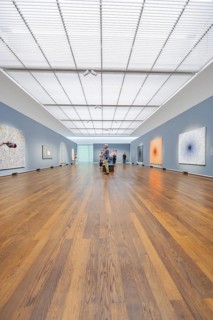 Large, illuminated gallery space with several visitors and works of art on the walls, Frieder Burda