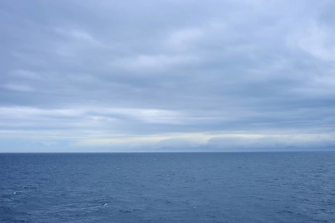 Vast sea under a cloudy sky with a view of distant horizons, summer, Cook Strait, North Island,