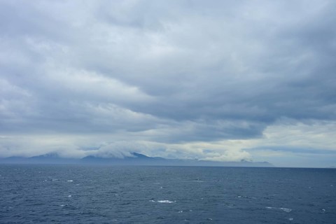 The wide sea under a cloudy sky with mountains in the distance, summer, Cook Strait, North Island,