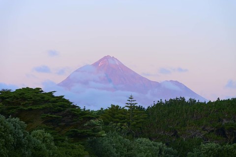 Volcano Mount Taranaki at dusk with clouds and surrounding vegetation, summer, Opunake, Taranaki,