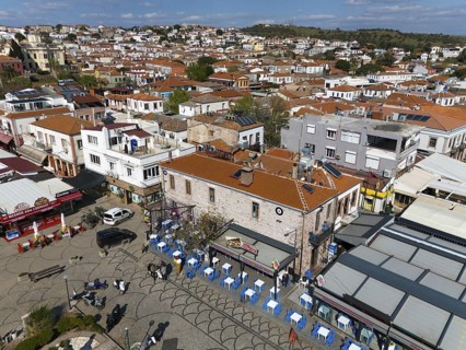 Bird's eye view of a busy town with narrow streets and visible colourful houses, aerial view,