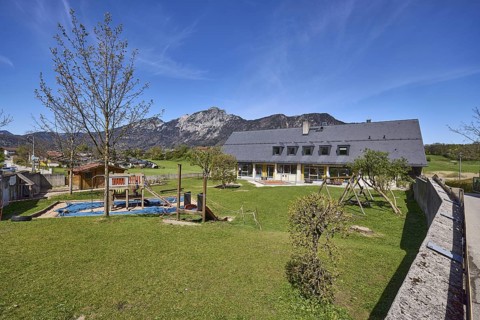 Catholic kindergarten St.Bruder Klaus, building, playground equipment, swing, sandpit, meadow,