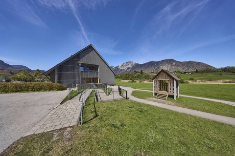 Catholic kindergarten St.Bruder Klaus, building, ramp, metal railing, meadows, mountain landscape,