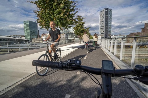 Cycling over the Moreelsebrug, pedestrian and cyclist bridge over the tracks of Utrecht Centraal,