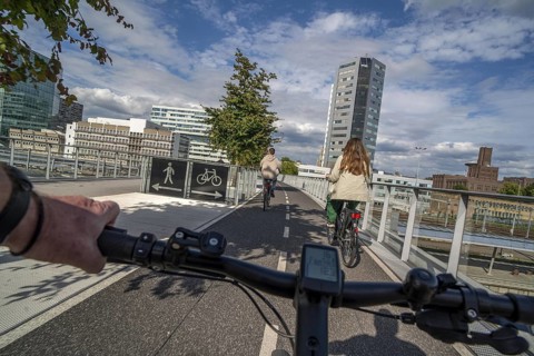 Cycling over the Moreelsebrug, pedestrian and cyclist bridge over the tracks of Utrecht Centraal,