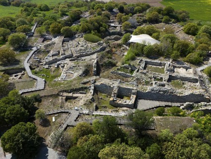 Historical ruins with ancient stone walls embedded in lush vegetation, aerial view, Troy, Troia,