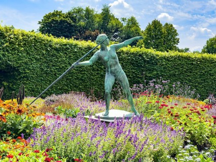 Sculpture Statue of bronze javelin thrower from 1937 by sculptor and artist Ernst Seger in flower
