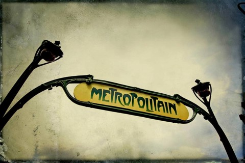 Captured from below, the iconic metro sign in Paris highlights its historic charm and significance