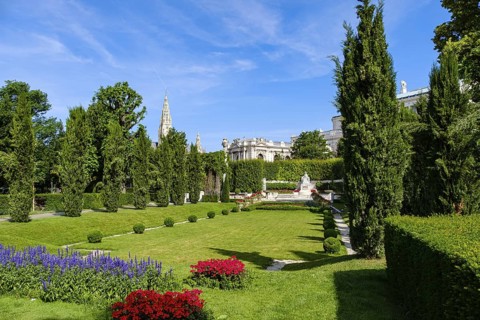 Vienna Volksgarten with a view of the famous Sisi Monument with the Town Hall Tower and the