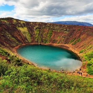 Hikers round Kerið, Kerid, crater lake with turquoise-green water, Golden Circle, ring road,