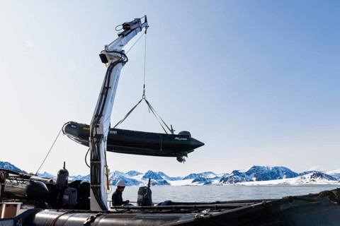 Zodiac on the hook of a ship, sea, Smeerenburg, Spitsbergen, Svalbard