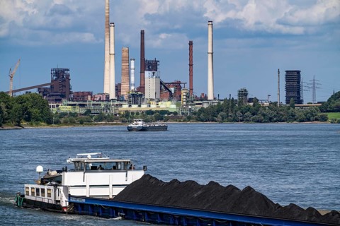 Industrial scenery of the ThyssenKrupp Steel steelworks in Duisburg-Bruckhausen, cargo ships on the