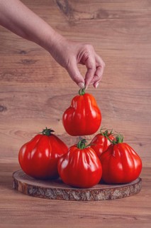Khinkali tomatoes, on a wooden cutting board, wooden background, no people