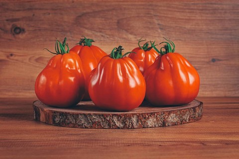 Khinkali tomatoes, on a wooden cutting board, wooden background, no people