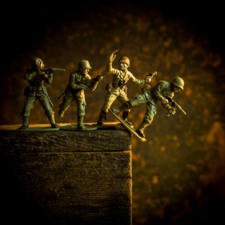 A group of toy soldiers are captured in motion as they navigate a steep incline, showcasing