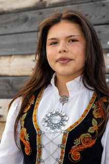 Young woman in traditional traditional costume at the reception for King Harald at the end of coal