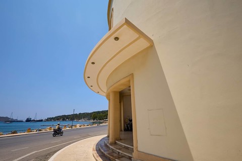 Theatre, Cinema, Round building side with arched architecture and view of street and sea, Armando