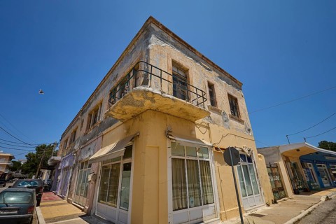 Persiana, Old building with worn façade and small balcony on a street corner, Armando Bernabiti,