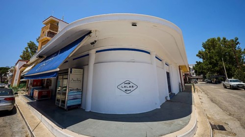 Fish market, Circular white building with blue awning, Street scene and shop signs, Armando