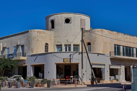 Municipal office, Farmazie, Corner building with round tower, café and open windows on a busy