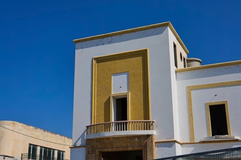 Modern building with geometric design and clear edges under a clear blue sky, Armando Bernabiti,