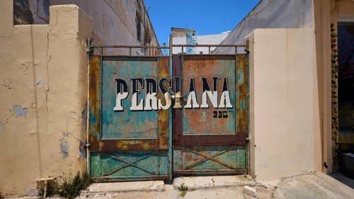 Persiana, Rusty Tor with the lettering Persiana on a dilapidated building, Armando Bernabiti,