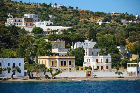 Yellow villa with surrounding trees on the seashore in a quiet location, Lakki, Leros, Dodecanese,