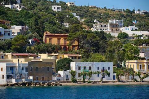 Colourful houses embedded in green vegetation on the coast, Lakki, Leros, Dodecanese, Greek