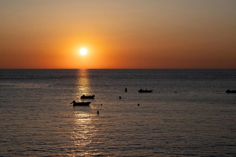 Boats in front of sunset at the sea, North Sea, English Channel, Étretat, evening mood,
