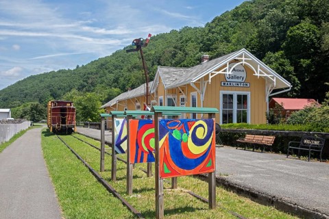 Marlinton, West Virginia - The Greenbrier River Trail runs past a restored train station which is