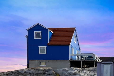 Typical architecture of Greenland Ilulissat with colored houses located near fjords and icebergs