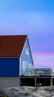 Typical architecture of Greenland Ilulissat with colored houses located near fjords and icebergs