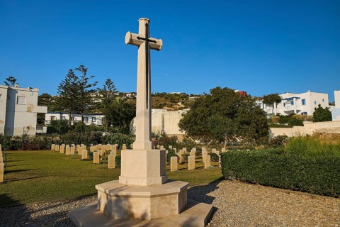 Large cross on a cemetery with surrounding buildings and trees, Military cemetery, Commonwealth War
