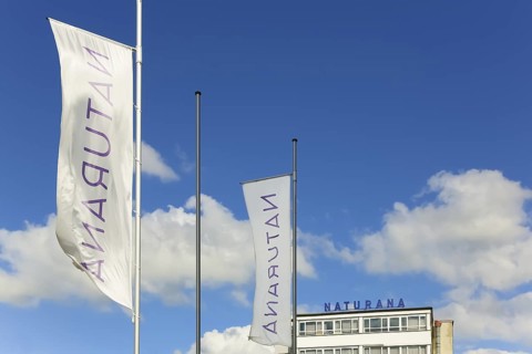 Naturana Miederfabriken, company building of Naturana Dölker Textilbekleidung, lettering, flags,