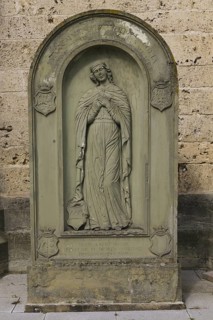 Old gravestone in front of St Martin's Church, catholic church, graceful female figure, relief,