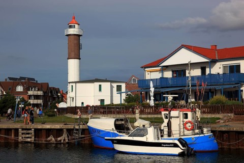 Timmendorf lighthouse on the island of Poel on the Baltic Sea, harbour in the foreground,