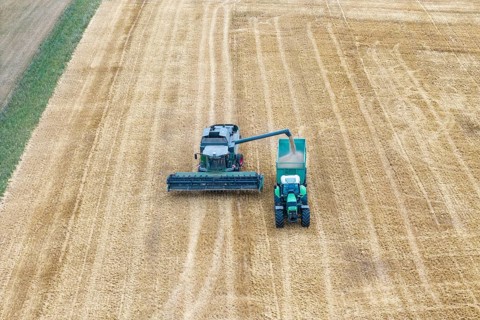 Closer look at a combine harvester loading crops onto a tractor, Korb im Rems Valley,