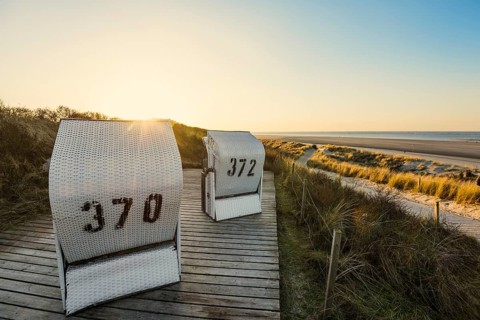 Beach chairs in the dunes and blue sky in winter, sunset, Spiekeroog, East Frisian Islands, Lower