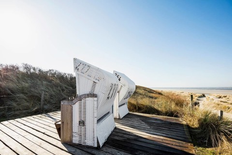 Beach chairs in the dunes and blue sky in winter, Spiekeroog, East Frisian Islands, Lower Saxony,