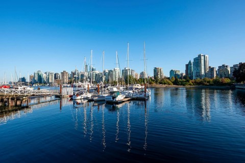 Skyscrapers and sailboats in the marina, Vancouver skyline reflected in the ocean, Coal Harbour,
