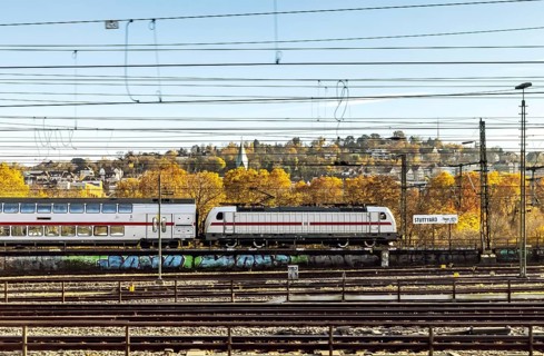 InterCity entering Stuttgart Central Station in autumn. Apron with station sign. Stuttgart,
