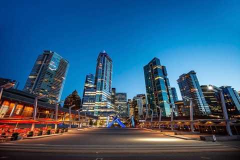 Illuminated skyscrapers on the promenade in the evening, Olympic Cauldron Statue, Jack Poole Plaza