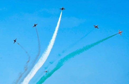 The Indian Air Force (IAF) Surya Kiran aerobatics team performs during an air show as part of the