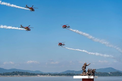 Indian Air Force (IAF) ALH Mk1 Sarang helicopters soar through the sky during an air show as part