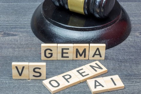 Letter cubes in front of a judge's hammer show the words GEMA VS OPEN AI
