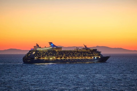 Mykonos, Cyclades, Greece - Voyager of the Seas cruise ship sails from Mykonos harbour bay towards