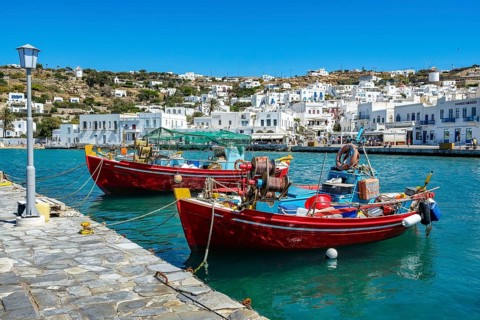 Mykonos, Cyclades, Greece - Colourful fishing boats are moored on the quay in the old port of
